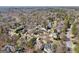 Scenic aerial view captures a community featuring luxury homes nestled among the mature trees at 210 Steeple Point Dr, Roswell, GA 30076