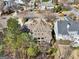 Aerial view showcasing the architectural design of a luxury home with a covered patio at 210 Steeple Point Dr, Roswell, GA 30076