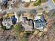 Aerial view of rooftops of a luxurious neighborhood showcasing the architectural design of the homes at 210 Steeple Point Dr, Roswell, GA 30076