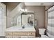 Bathroom features a large mirror above the vanity with a white countertop and a toilet in a niche at 210 Steeple Point Dr, Roswell, GA 30076