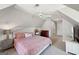 Cozy bedroom with sloped ceilings and a comfortable bed at 210 Steeple Point Dr, Roswell, GA 30076