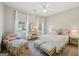 Charming bedroom with a floral armchair, vanity, and a bright window view at 210 Steeple Point Dr, Roswell, GA 30076