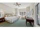 Spacious bedroom with a ceiling fan, natural light, and a separate sitting area at 210 Steeple Point Dr, Roswell, GA 30076