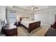 Spacious bedroom showcasing a large bed, tray ceilings and natural light at 210 Steeple Point Dr, Roswell, GA 30076