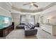 Bonus room features a comfortable grey couch, television and natural light from the windows at 210 Steeple Point Dr, Roswell, GA 30076