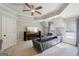Bonus room features a modern ceiling fan, a large television, and a comfortable grey couch at 210 Steeple Point Dr, Roswell, GA 30076