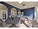 A lovely covered patio boasts wood floors, exterior grade couches and a dining area at 210 Steeple Point Dr, Roswell, GA 30076