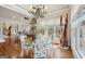 Bright dining area with a modern chandelier, large windows, and wood floors at 210 Steeple Point Dr, Roswell, GA 30076