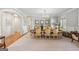 Formal dining room with chandelier, plush carpeting, and elegant furnishings at 210 Steeple Point Dr, Roswell, GA 30076
