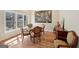 Bright dining room with wood floors, a glass table, and elegant chairs, ideal for Gathering meals at 210 Steeple Point Dr, Roswell, GA 30076