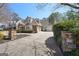 Spacious driveway leading to a charming multi-car garage, surrounded by lush landscaping at 210 Steeple Point Dr, Roswell, GA 30076
