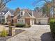 Beautiful home featuring a two-car garage and driveway, manicured landscaping, and classic design elements at 210 Steeple Point Dr, Roswell, GA 30076