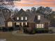 Beautifully designed home showcasing brick and siding, mature landscaping, and a welcoming front entrance at 210 Steeple Point Dr, Roswell, GA 30076