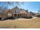 Multi-story home with a brick facade and inviting front yard at 210 Steeple Point Dr, Roswell, GA 30076