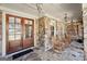 Charming stone porch with wooden rocking chairs and double doors at 210 Steeple Point Dr, Roswell, GA 30076