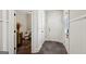 Entry hallway leading to a powder room, featuring slate tile flooring and paneled wainscoting at 210 Steeple Point Dr, Roswell, GA 30076