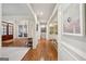 Inviting hallway with hardwood floors, arched openings, and elegant decor at 210 Steeple Point Dr, Roswell, GA 30076