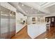 Spacious kitchen features stainless steel appliances, white cabinetry, and a large center island with wood flooring at 210 Steeple Point Dr, Roswell, GA 30076