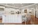 Modern kitchen with white cabinets, quartz countertops, stainless steel appliances, and bar seating at 210 Steeple Point Dr, Roswell, GA 30076