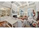 Bright living room featuring coffered ceilings, fireplace, built-in shelving, and outdoor access at 210 Steeple Point Dr, Roswell, GA 30076