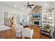 Cozy living room featuring a stone fireplace, built-in shelving, and hardwood floors at 210 Steeple Point Dr, Roswell, GA 30076