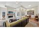Spacious living room featuring a fireplace, ceiling fan, and elegant decor, perfect for relaxation and entertaining at 210 Steeple Point Dr, Roswell, GA 30076