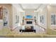 Bright living room featuring a fireplace, high ceilings, and large windows at 210 Steeple Point Dr, Roswell, GA 30076