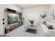 Contemporary living room with sleek furniture, a decorative plant, and modern entertainment center at 210 Steeple Point Dr, Roswell, GA 30076