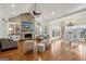 Open living area with stone fireplace, hardwood floors, and adjacent dining space at 210 Steeple Point Dr, Roswell, GA 30076
