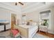 Bright main bedroom features a tray ceiling, a large bed and access to the main bath at 210 Steeple Point Dr, Roswell, GA 30076