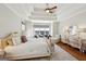 Bright main bedroom features a sitting area, coffered ceilings, and beautiful hardwood floors at 210 Steeple Point Dr, Roswell, GA 30076