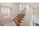 Staircase with carpeted steps and an ornate wooden railing at 210 Steeple Point Dr, Roswell, GA 30076