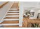 Staircase leading to a lower level with an open kitchen and dining area at 210 Steeple Point Dr, Roswell, GA 30076