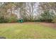Large, grassy backyard with sports equipment and a small green outbuilding at 10174 Twin Oaks Sw Dr, Covington, GA 30014