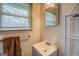 Bathroom with window, mirror, and sink, providing a bright and airy space for personal hygiene at 10174 Twin Oaks Sw Dr, Covington, GA 30014