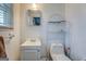 Bathroom featuring a sink, toilet, and vanity, offering a compact and functional space for daily routines at 10174 Twin Oaks Sw Dr, Covington, GA 30014