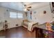 Bedroom with wood floor, ceiling fan, and natural light, creating a cozy and inviting personal space at 10174 Twin Oaks Sw Dr, Covington, GA 30014