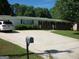 Charming single-story home features a green roof, brick accents, and a spacious driveway, offering comfortable suburban living at 10174 Twin Oaks Sw Dr, Covington, GA 30014