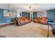 Comfortable living room with neutral carpet, cozy seating, and ample space at 10174 Twin Oaks Sw Dr, Covington, GA 30014
