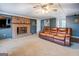 Cozy living room with a brick fireplace, plush sofa, and neutral colored walls at 10174 Twin Oaks Sw Dr, Covington, GA 30014