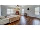 Bright main bedroom features hardwood floors, natural light, and a ceiling fan at 10174 Twin Oaks Sw Dr, Covington, GA 30014