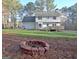 Expansive backyard featuring a spacious deck, and a fire pit, perfect for outdoor gatherings at 215 Farr Lake Dr, Tyrone, GA 30290