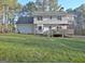 Spacious backyard with manicured lawn and large deck perfect for entertaining guests at 215 Farr Lake Dr, Tyrone, GA 30290
