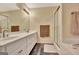 Well-appointed bathroom featuring double sinks, a glass-enclosed shower, and sleek white cabinets at 215 Farr Lake Dr, Tyrone, GA 30290