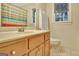 Bathroom featuring a sink and vanity, toilet and a shower with a colorful striped curtain at 215 Farr Lake Dr, Tyrone, GA 30290