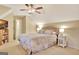 Relaxing bedroom with a ceiling fan, with a bed and a tv at 215 Farr Lake Dr, Tyrone, GA 30290