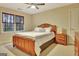 Bedroom with carpet, ceiling fan, windows, and traditional wood bedroom furniture at 215 Farr Lake Dr, Tyrone, GA 30290