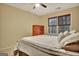 Bedroom featuring a comfortable bed, wood furniture, carpet, and large windows at 215 Farr Lake Dr, Tyrone, GA 30290