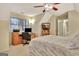 Bright bedroom with a sloped ceiling, desk with a computer, and a ceiling fan at 215 Farr Lake Dr, Tyrone, GA 30290