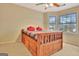 Bright bedroom with a ceiling fan, a bed with drawers, and a window view at 215 Farr Lake Dr, Tyrone, GA 30290